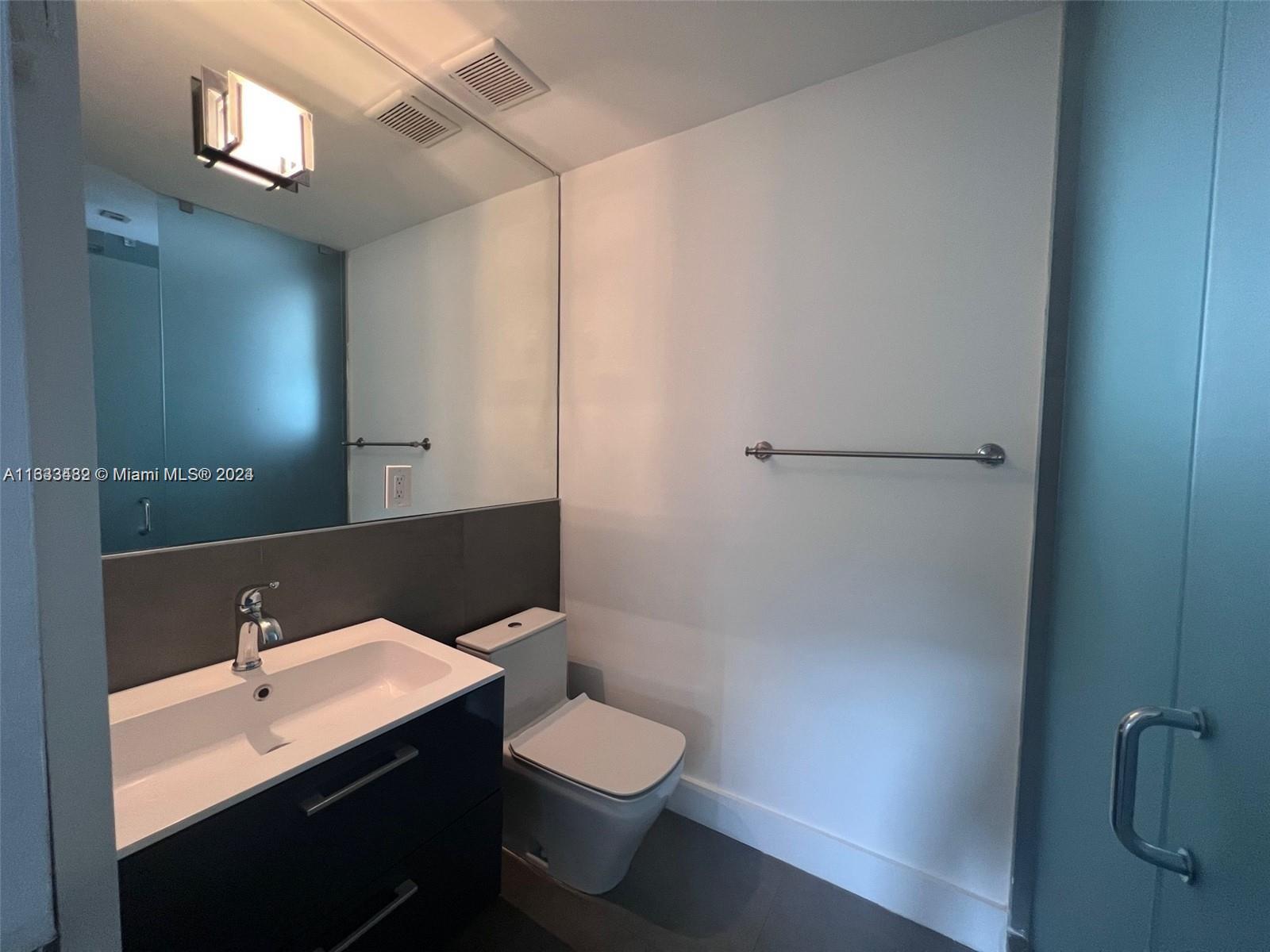 600 15th Street, Unit 4 Miami Beach, FL 33139 - Photo 8 of 15 a bathroom with a sink a toilet and shower