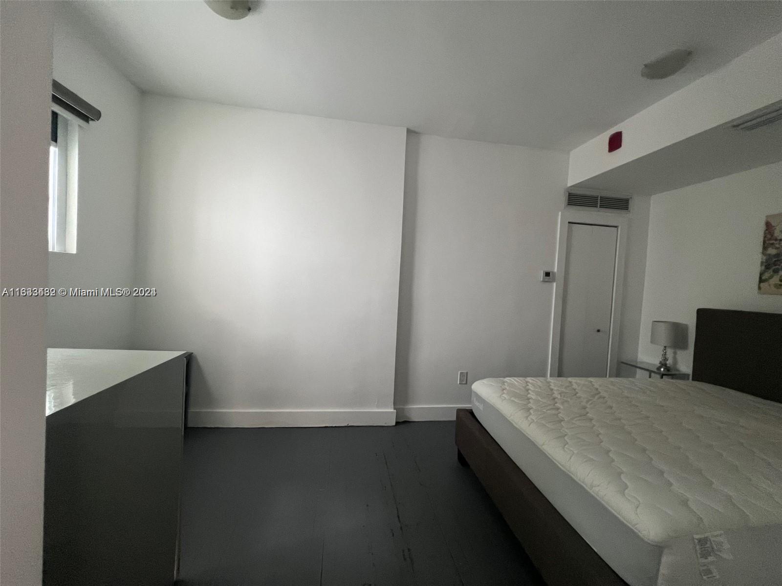600 15th Street, Unit 4 Miami Beach, FL 33139 - Photo 9 of 15 a room with a bed and a flat screen tv