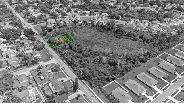 an aerial view of residential houses with city view