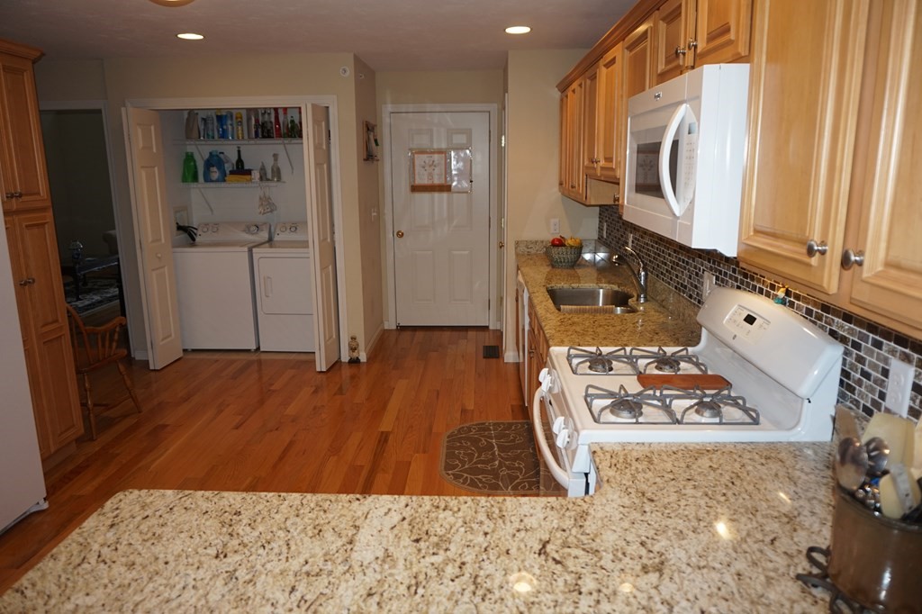 29 Riley Road, Unit 29 Lunenburg, MA 01462 - Photo 12 of 35 a view of a wooden floor and a kitchen