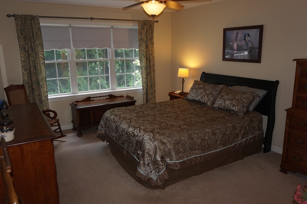 29 Riley Road, Unit 29 Lunenburg, MA 01462 - Photo 23 of 35 a bed sitting in a bedroom next to a lamp next to a window