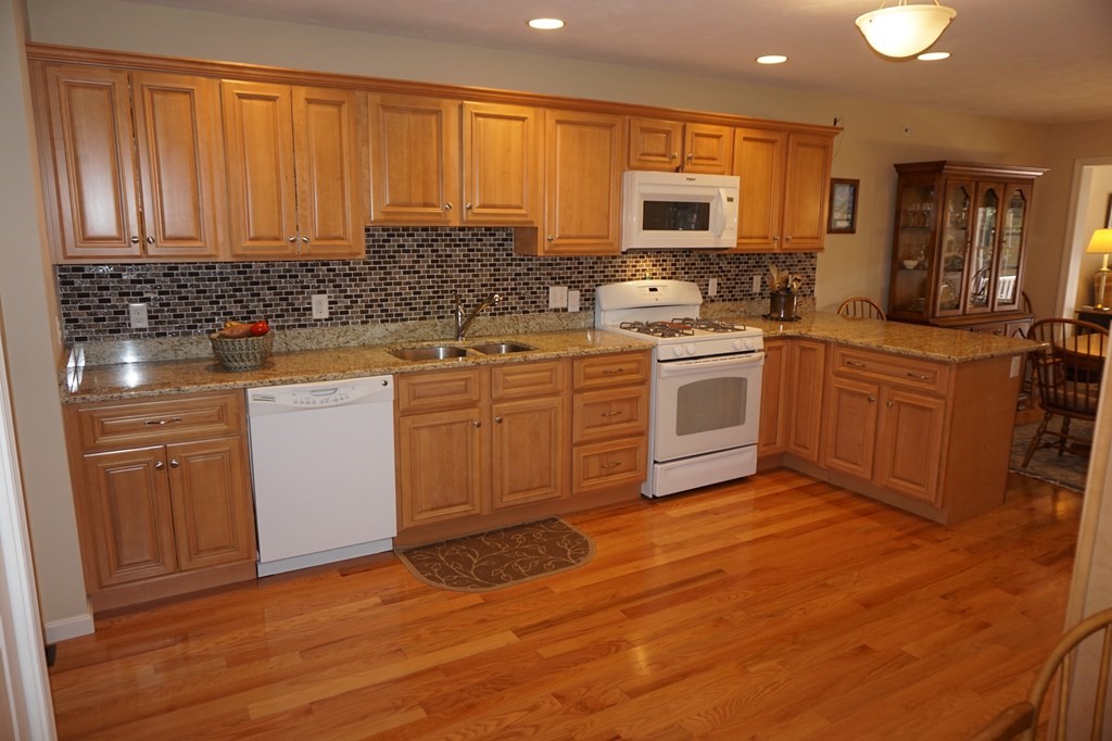 29 Riley Road, Unit 29 Lunenburg, MA 01462 - Photo 7 of 35 a kitchen with stainless steel appliances granite countertop a stove sink and cabinets
