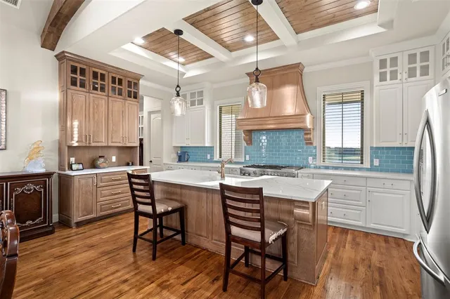 a kitchen with a table chairs stove and cabinets
