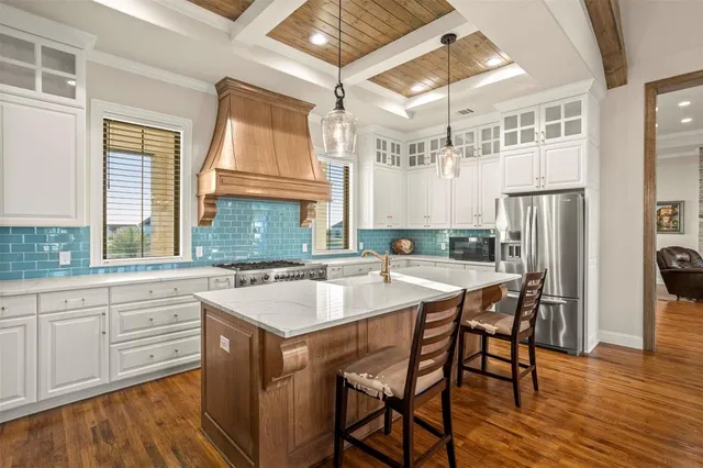 a kitchen with a stove a sink and a refrigerator