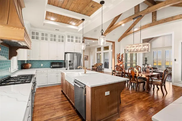a open kitchen with stainless steel appliances granite countertop a stove and cabinets