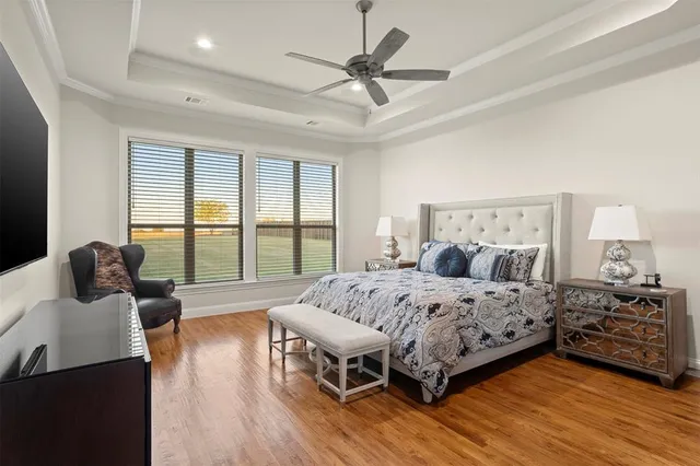 a bedroom with a large bed and a large window