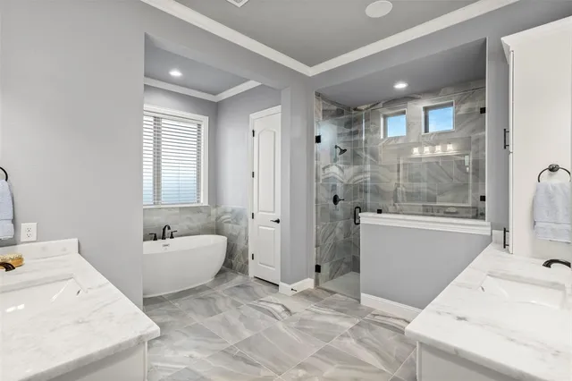 a bathroom with a tub sink and mirror