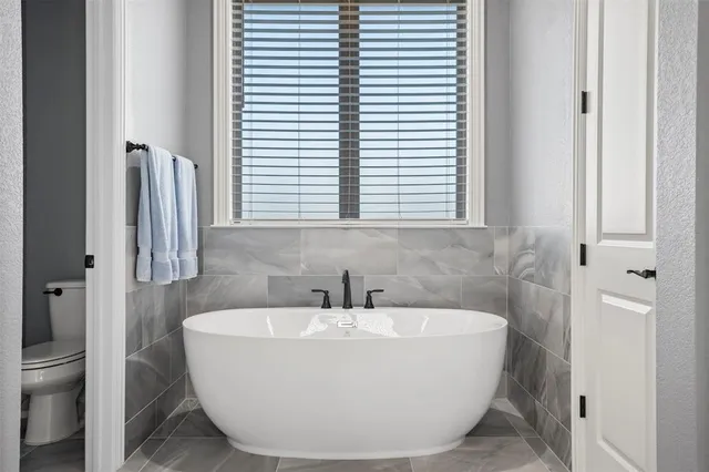 a white bath tub sitting next to a white sink