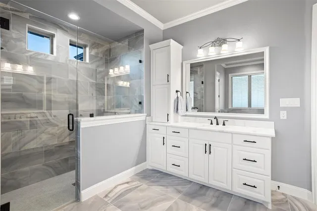 a spacious bathroom with a double vanity sink a mirror and a shower
