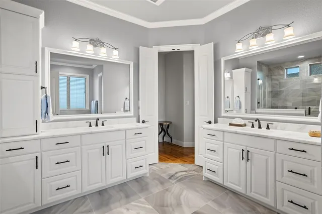 a spacious bathroom with double sink and a mirror