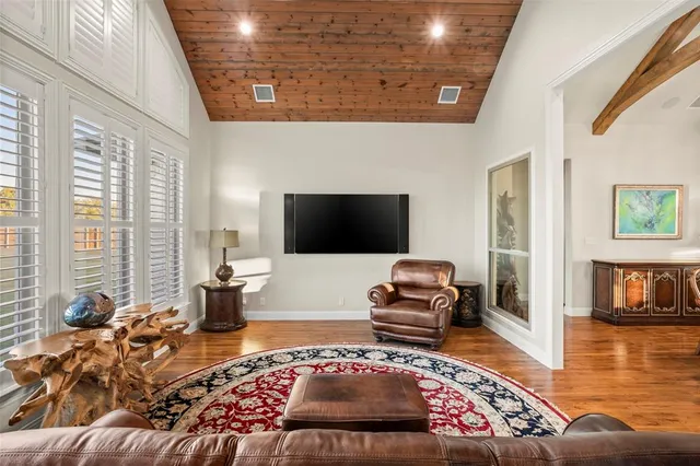 a living room with furniture rug and a flat screen tv