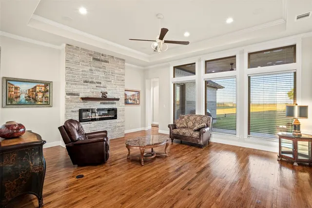 a living room with furniture wooden floor and window