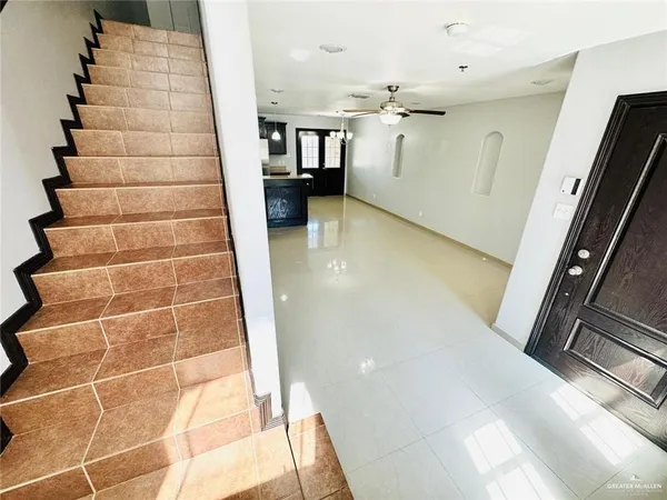 a kitchen with stainless steel appliances a stove a sink and a refrigerator with cabinets