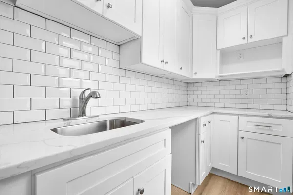 a bathroom with a sink a mirror and shower