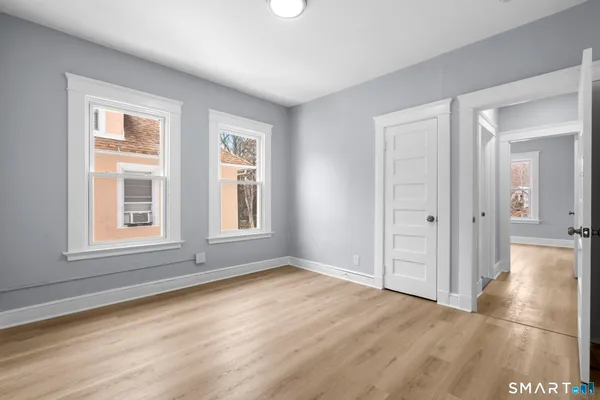 a view of staircase with wooden floor and a living room