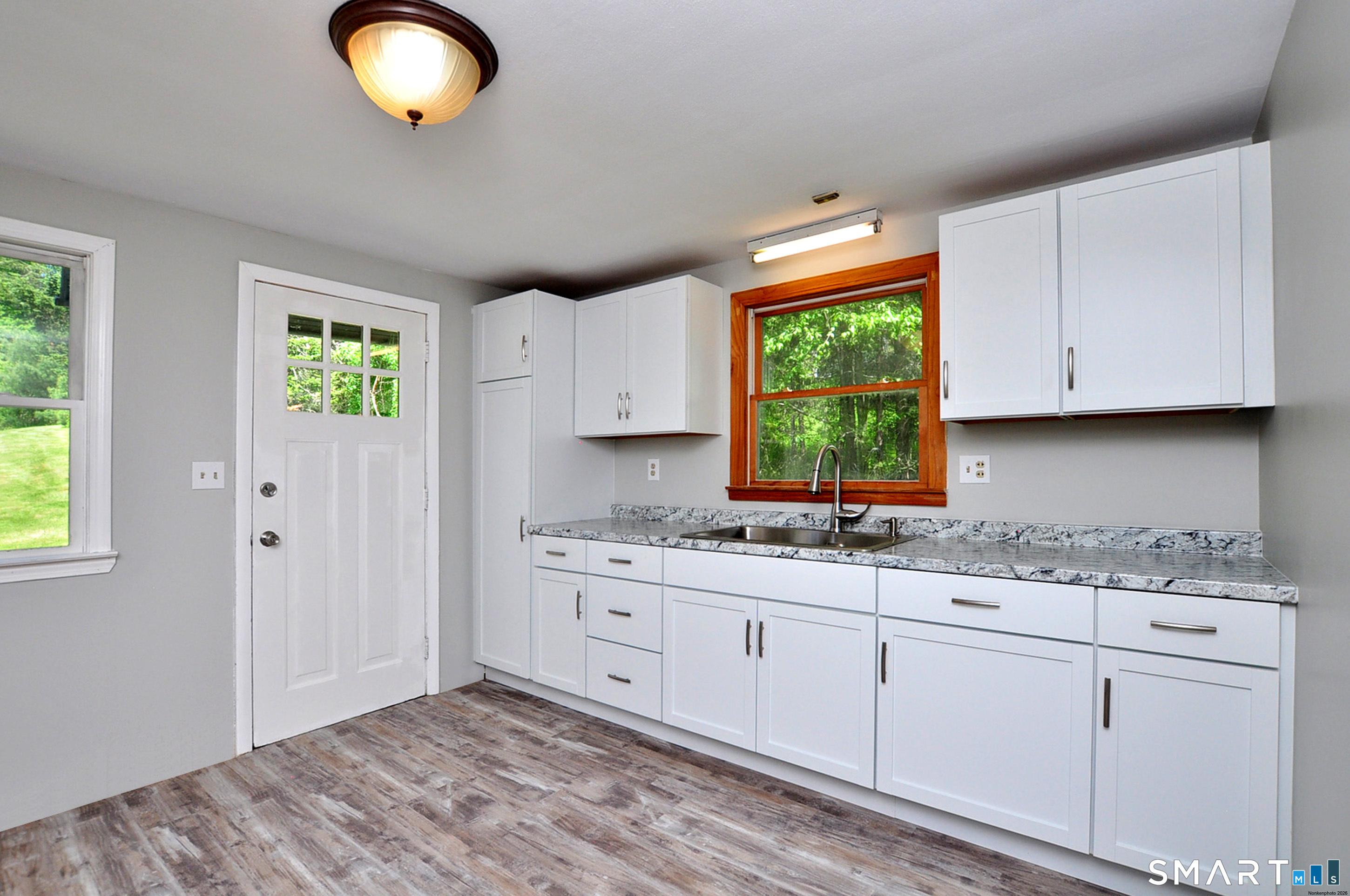 526 Granville Road Hartland, CT 06027 - Photo 19 of 37 Kitchen with new flooring, cabinetry, countertop and double sink