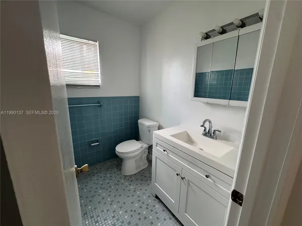 a bathroom with a sink toilet and vanity