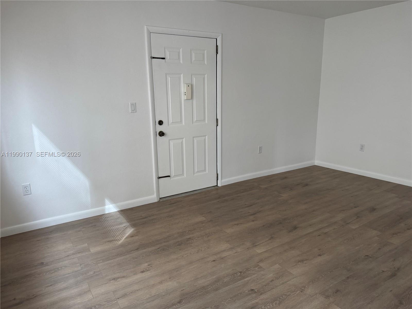 4080 Southwest 2nd Terrace, Unit 6 Miami, FL 33134 - Photo 4 of 14 a view of an empty room with wooden floor