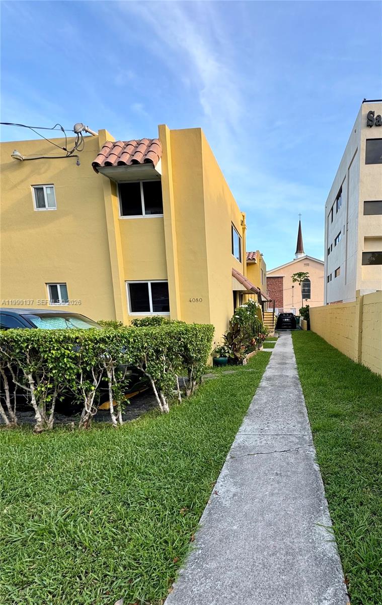 4080 Southwest 2nd Terrace, Unit 6 Miami, FL 33134 - Photo 10 of 14 a front view of a house with a yard