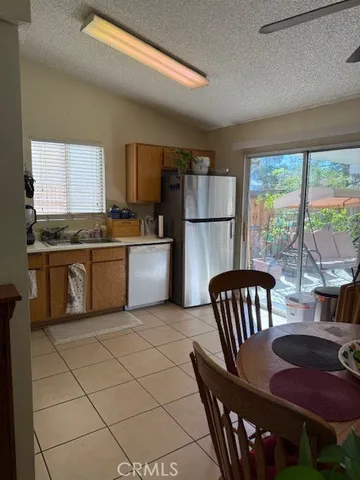 a kitchen with a table chairs and a refrigerator