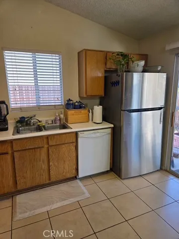 a kitchen with a refrigerator and a sink