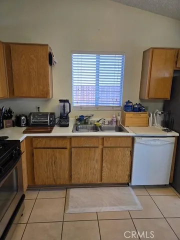 a kitchen with stainless steel appliances granite countertop a sink and a stove