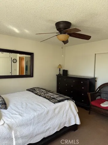a bedroom with bed and a chandelier