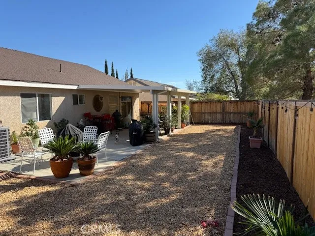 a view of a patio with table and chairs potted plants with wooden floor