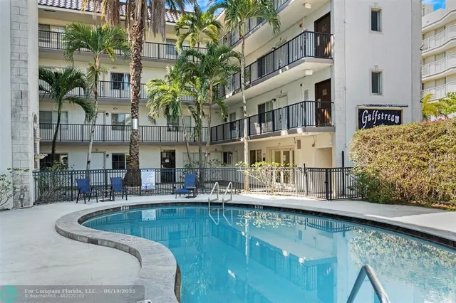 a view of a swimming pool with outdoor seating