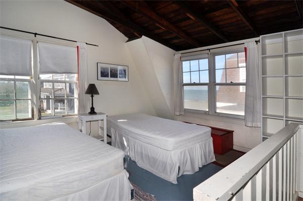 68 Baileys Ledge Road Little Compton, RI 02837 - Photo 20 of 30 a spacious bedroom with two beds and a large window