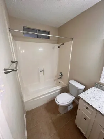 a view of an empty room with a chandelier fan