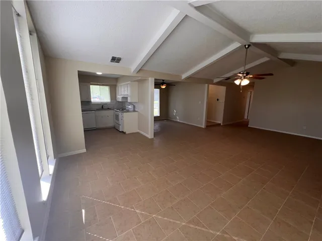 a kitchen with stainless steel appliances a refrigerator sink and white cabinets