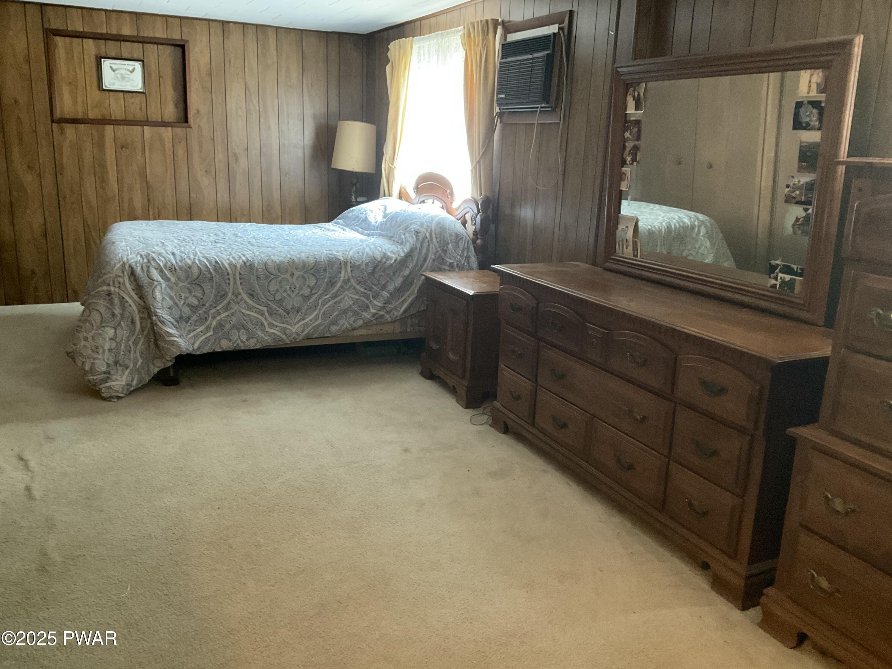 124 Roundhill Road Dingmans Ferry, PA 18328 - Photo 38 of 47 a bedroom with a bed and a mirror
