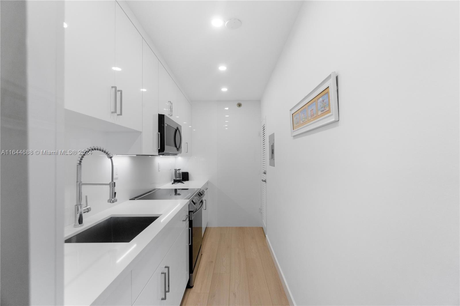 100 Lincoln Road, Unit 1104 Miami Beach, FL 33139 - Photo 21 of 24 a kitchen with a sink cabinets and utility