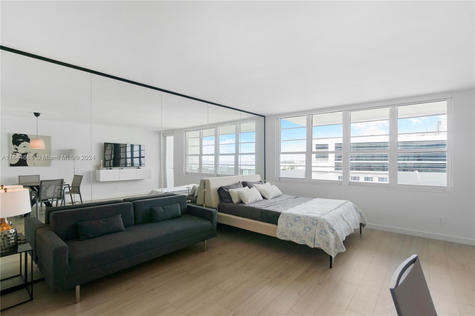 100 Lincoln Road, Unit 1104 Miami Beach, FL 33139 - Photo 23 of 24 a spacious bedroom with a bed couch and a window