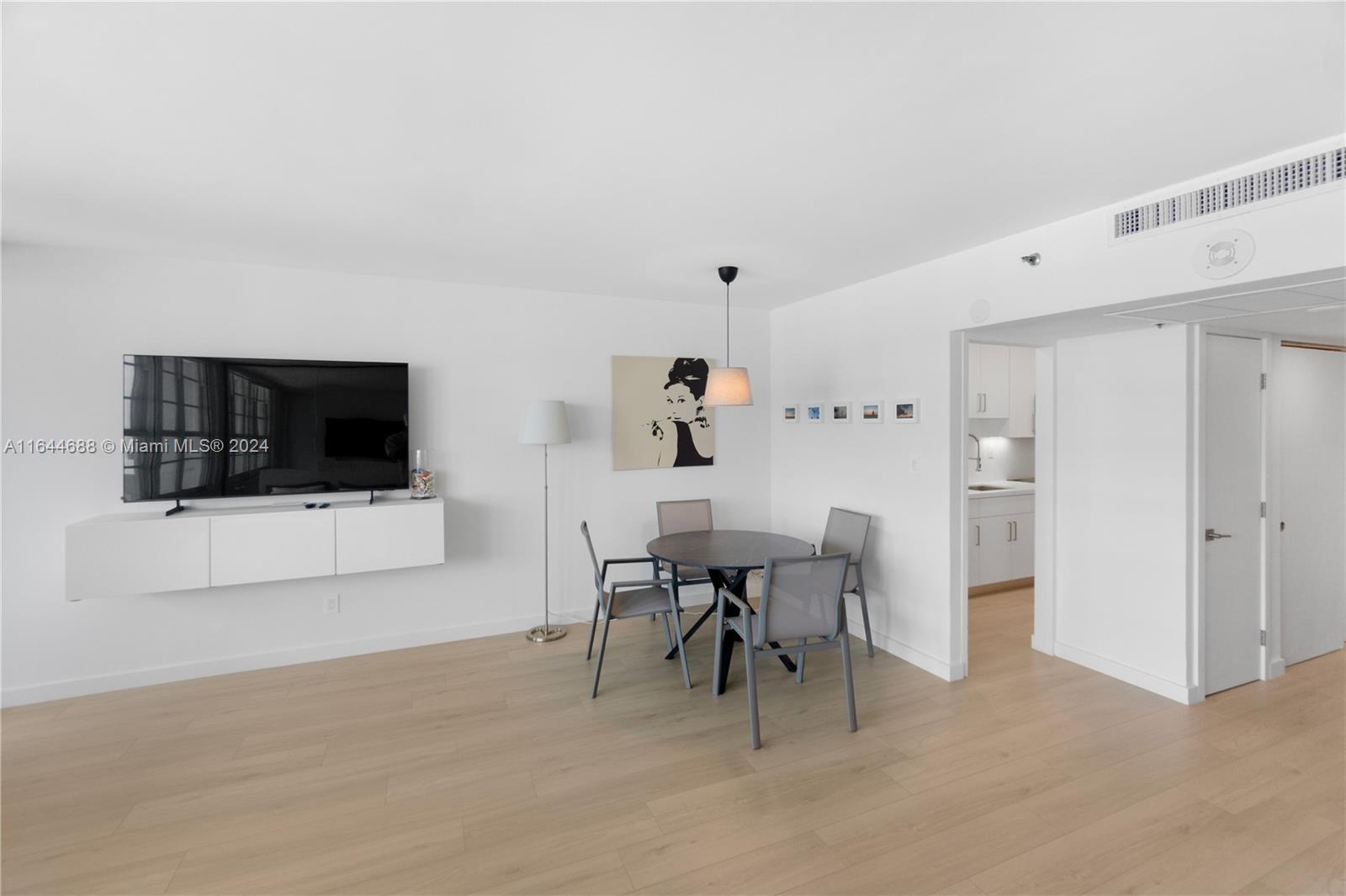 100 Lincoln Road, Unit 1104 Miami Beach, FL 33139 - Photo 8 of 24 a living room with furniture and a flat screen tv