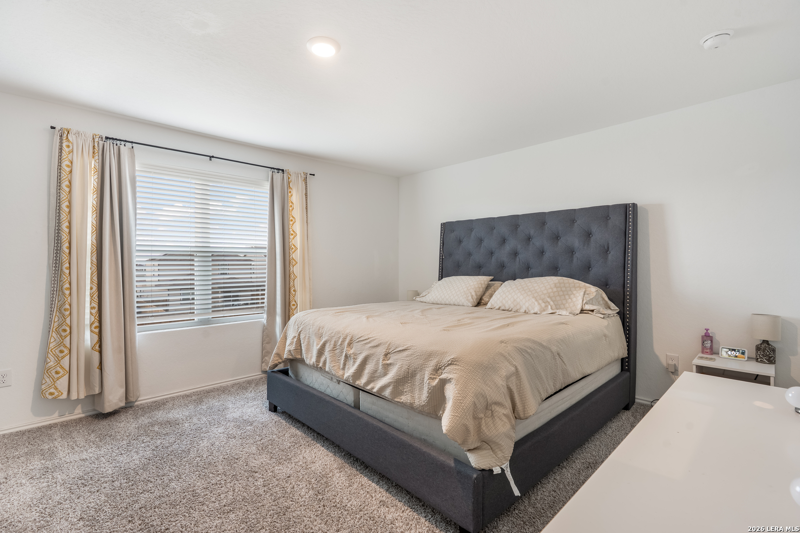 4103 Winchester Cove Converse, TX 78109 - Photo 18 of 32 a bed sitting in a spacious bedroom next to a window