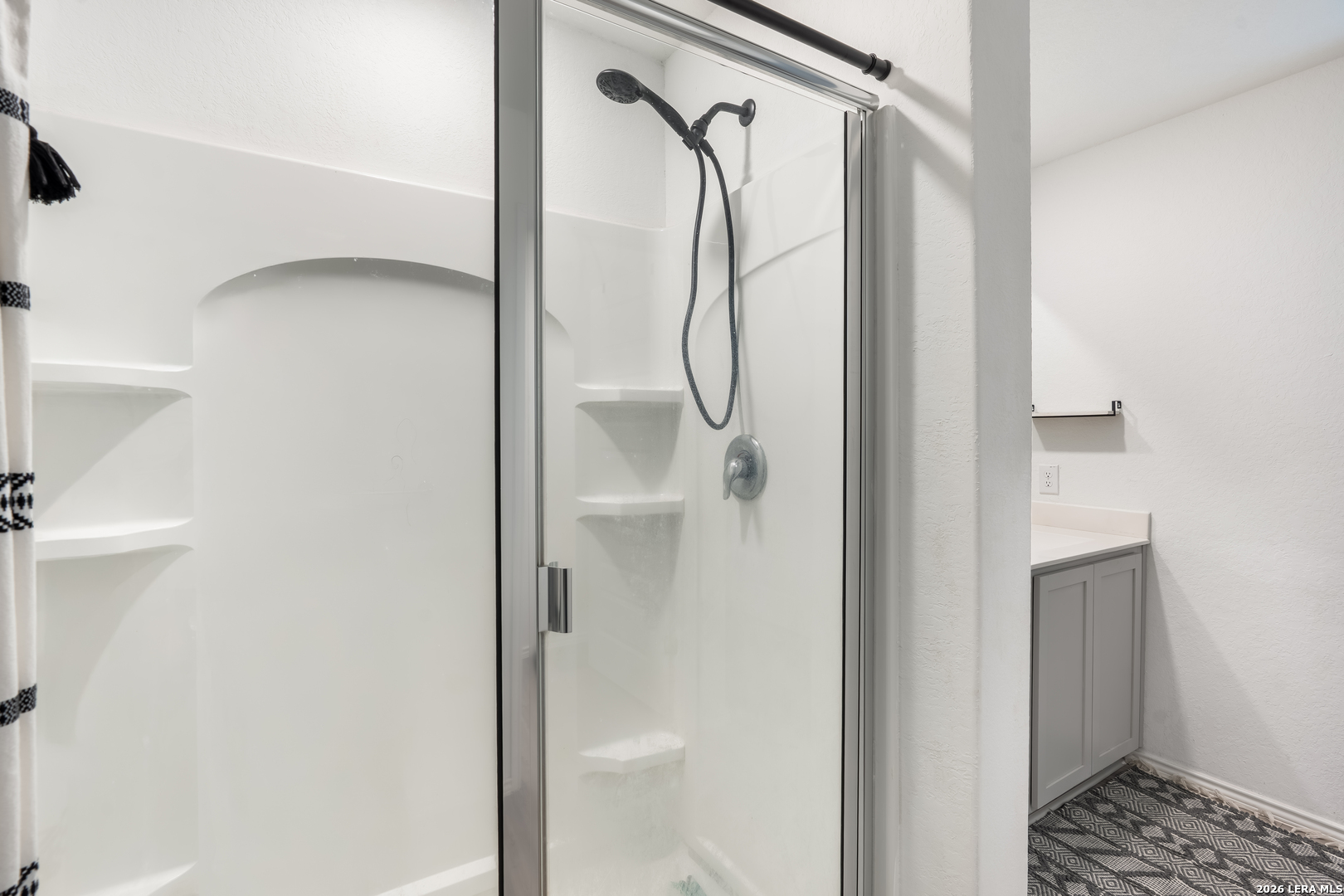 4103 Winchester Cove Converse, TX 78109 - Photo 20 of 32 a bathroom with a glass shower door