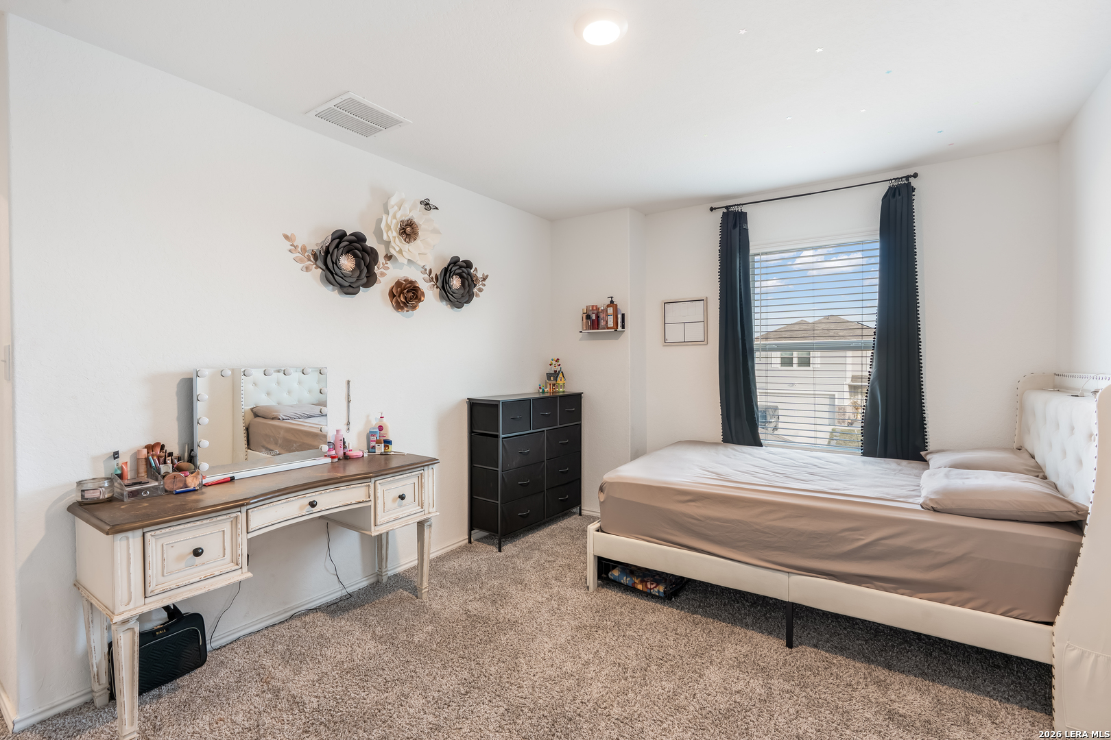 4103 Winchester Cove Converse, TX 78109 - Photo 28 of 32 a bedroom with a bed and a chandelier