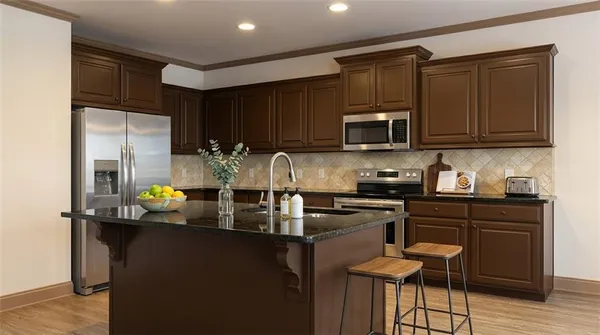 a kitchen with refrigerator and cabinets