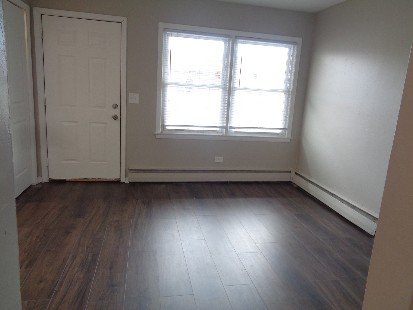 1340 North Main Street, Unit C4 Wheaton, IL 60187 - Photo 2 of 8 an empty room with wooden floor and windows