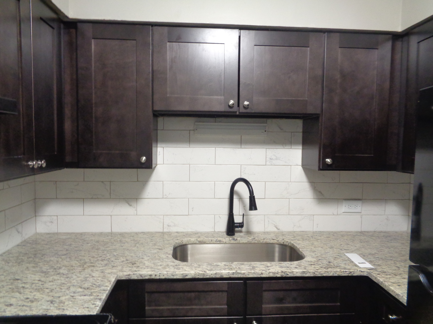 1340 North Main Street, Unit C4 Wheaton, IL 60187 - Photo 4 of 8 a kitchen with granite countertop wooden cabinets and granite counter