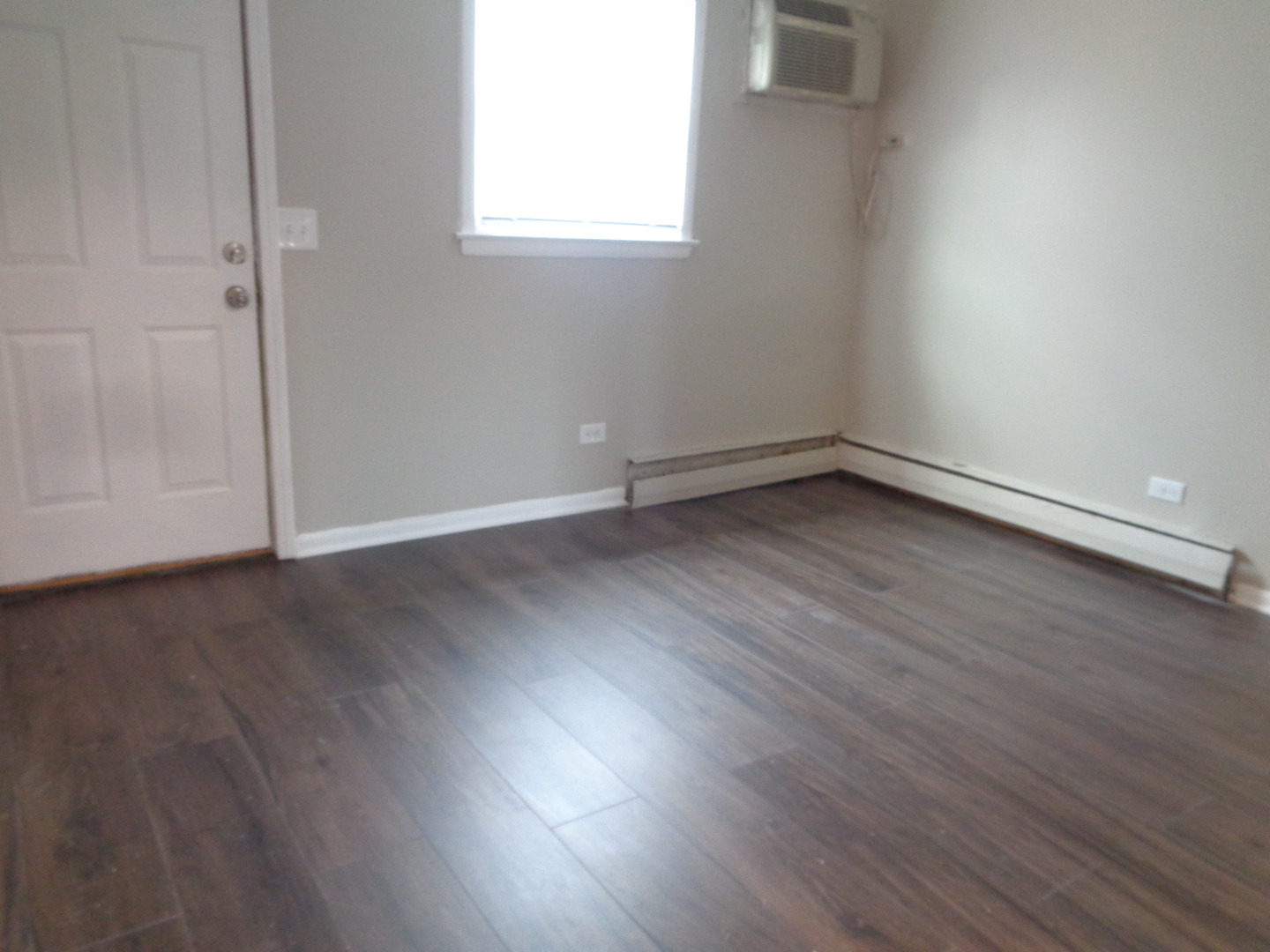 1340 North Main Street, Unit C4 Wheaton, IL 60187 - Photo 7 of 8 an empty room with wooden floor and windows