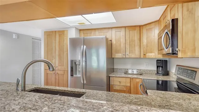 a bathroom with a granite countertop sink mirror and bathtub