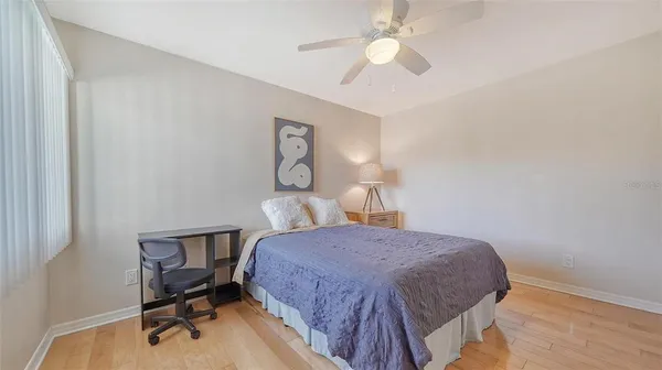 a view of a lake with a yard and large trees