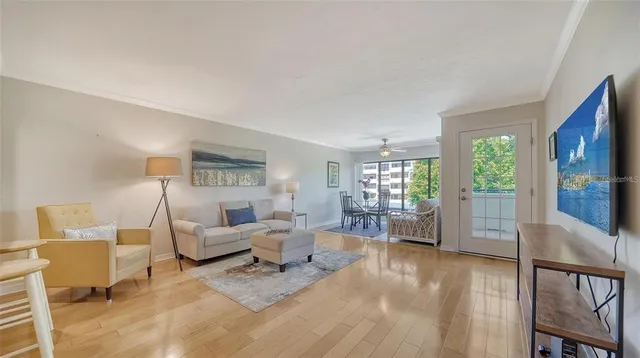 a living room with furniture a window and a flat screen tv