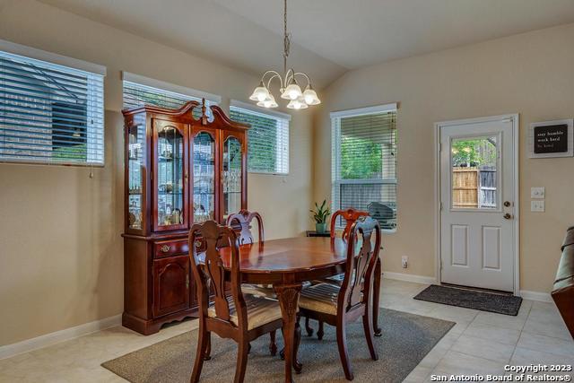 12515 Ponder Ranch San Antonio, TX 78245 - Photo 13 of 27 a view of a dining room with furniture and chandelier