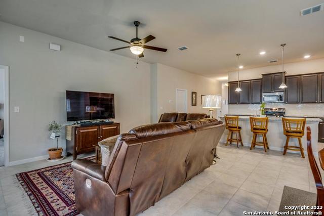 12515 Ponder Ranch San Antonio, TX 78245 - Photo 15 of 27 a living room with furniture and a flat screen tv