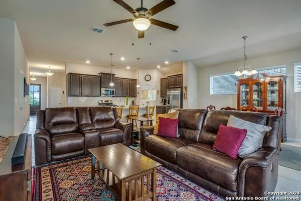 a living room with furniture and a chandelier