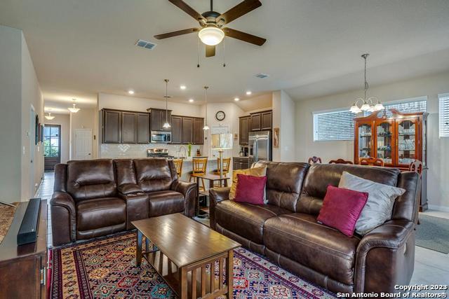 12515 Ponder Ranch San Antonio, TX 78245 - Photo 16 of 27 a living room with furniture and a chandelier